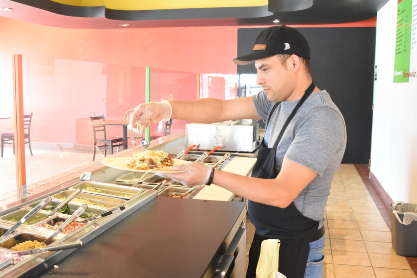 Alex Sanchez constructs a burrito on opening day June 13, 2020, at Hernandez Burrito in Sauk Rapids. The business, which is now located at the corner of Division Street and Second Avenue North, will be closed permanently March 29.