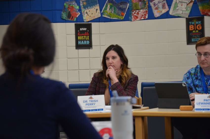 Foley Superintendent Trish Perry listens to a question from a Foley School Board member March 17 during a meeting at Foley Intermediate School in Foley. At the meeting, board members removed a budget reduction item from the agenda, requesting more time to review material related to the topic.