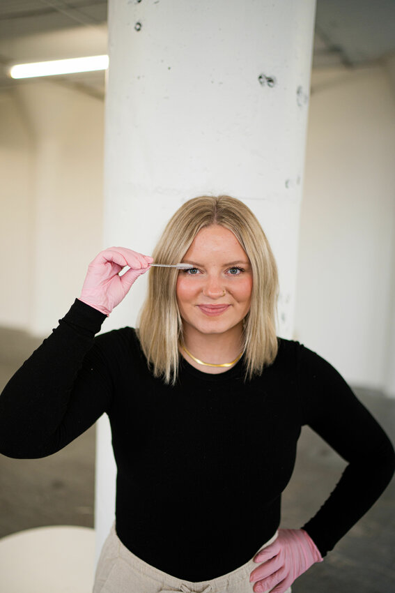 Shelby Gondeck performs an eyelash lift on herself last December during a photoshoot in St. Paul. She launched Glow with Shelby Feb. 18, a one-woman beauty business within Blue Door Salon, Spa and Boutique in Foley.