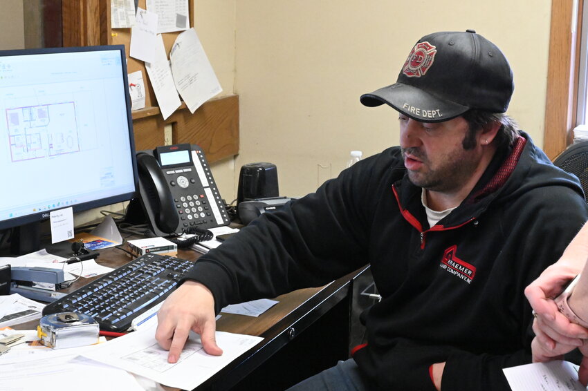 Joe Woeste looks over plans for construction April 10 in his office at Kraemer Lumber Co. Inc. in Sauk Centre. There is still uncertainty surrounding whether tariffs will impact local business, Woeste said.