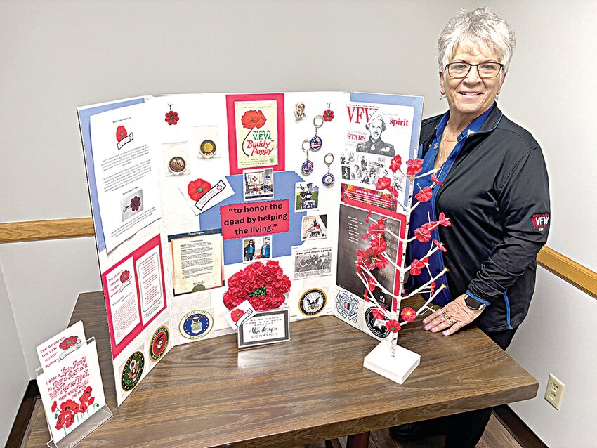 Karen Wolbeck, Sauk Rapids VFW Post 6992 Auxiliary conductress and poppy distribution chair, prepares to provide a poppy history lesson after setting up a traveling display April 21 in Sauk Rapids. Poppy distribution is scheduled at the following Sauk Rapids locations the first weekend in May: Coborn’s Marketplace, Manea’s Meats, Sauk Rapids Liquor and VFW post, Wolbeck said.