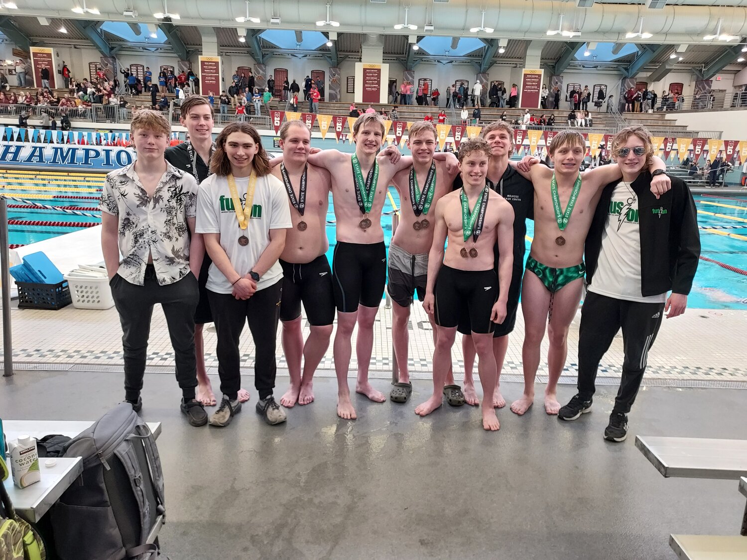 Melrose-Sauk Centre Fusion athletes — Hunter Leslie (front, from left), Andrue Stalboerger and Grant Eveslage; (back, from left) Nolan Fleischhacker, Macen Toavs-Etcheverry, Alex Wilwerding, Sevrin Anderson, alternate Zaron Olmschenk, Sam Stangler and Sullivan Stumler — receive their Minnesota State High School League Class A Boys Swimming and Diving State Meet medals March 8 at Jean K. Freeman Aquatic Center in Minneapolis. They earned enough points to finish in the top eight as a team at state.