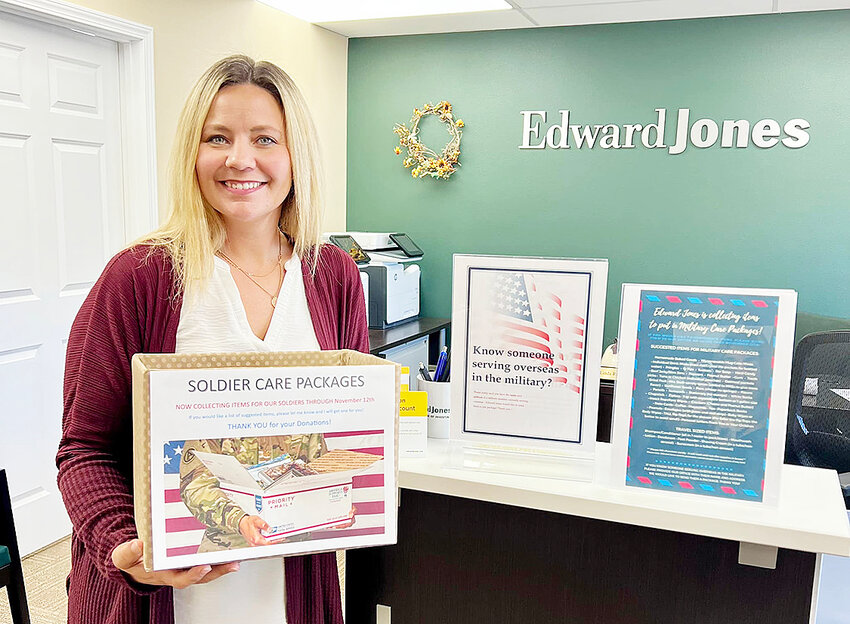 Edward Jones Storm Lake branch office administrator Linda Ricklefs with a soldier care package.