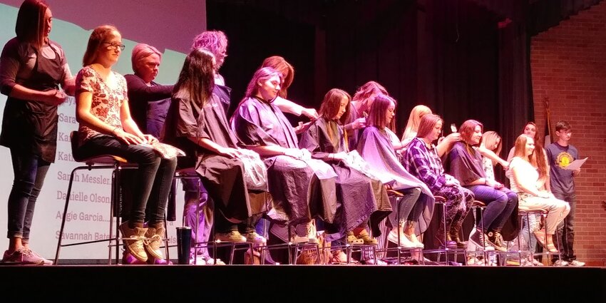 Washington High School students have their locks trimmed as part of an earlier Cut-a-Thon.