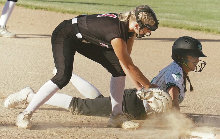 Storm Lake’s Olivia Speers dives back to first base   before Estherville’s Kacie Brechwald can tag her during Wednesday’s game. TIMES PILOT photo by JAMIE KNAPP