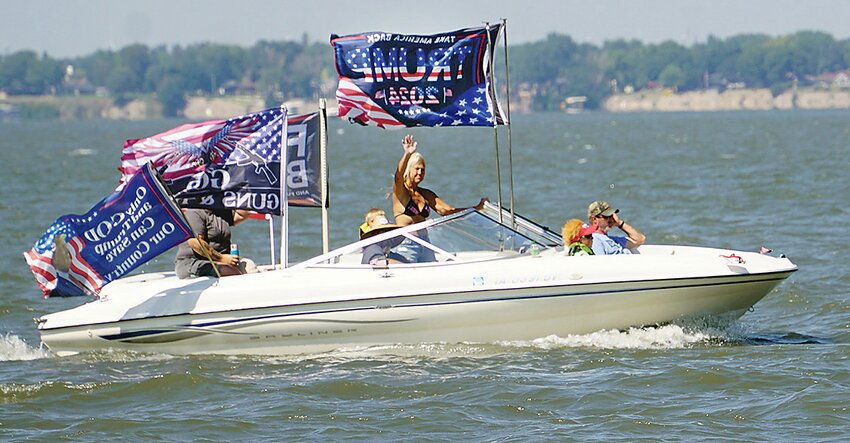 Participants in the Trump boat parade proudly display “Trump 2024” flags on their boats as they sail on Storm Lake on Sunday.