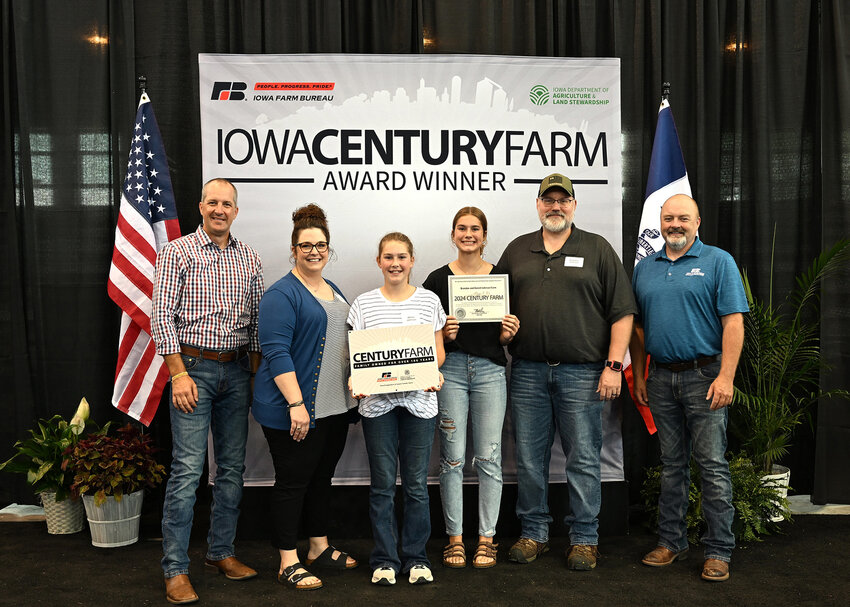 Iowa Secretary of Agriculture Mike Naig and Iowa Farm Bureau President Brent Johnson with Brandon and Darrel Johnson, Marcus, 1900 Century Farm.