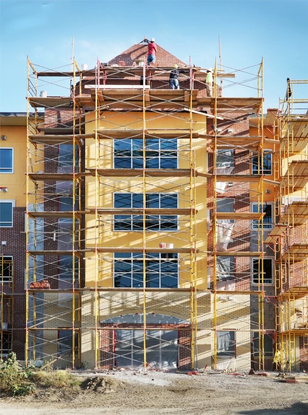 The new residence hall at Buena Vista University is rapidly taking shape. Workers on Friday were topping off the brick peak on the roof.