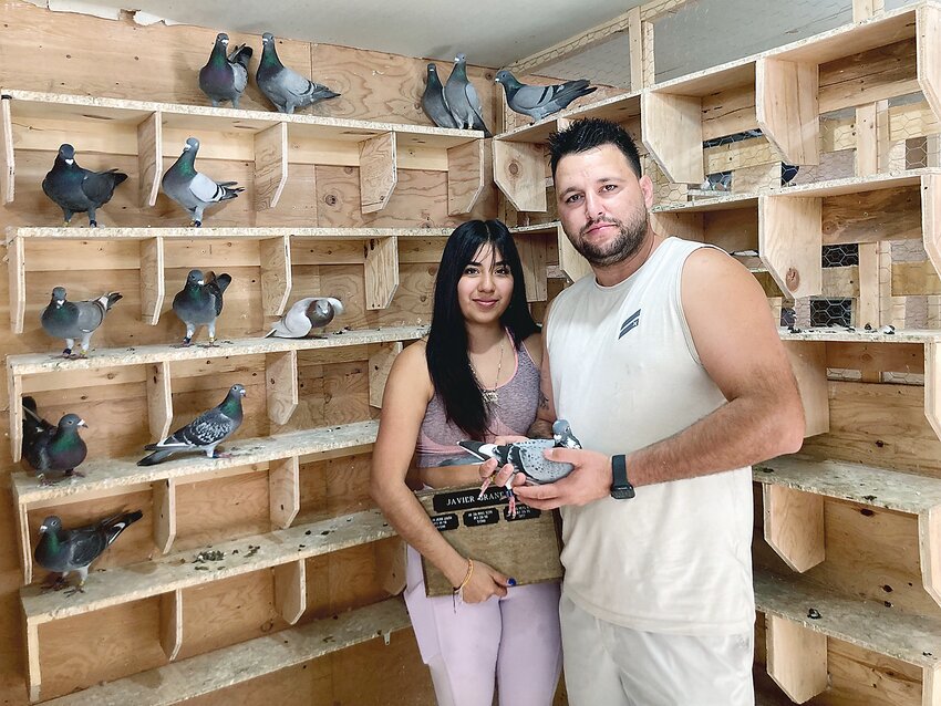 Javier Granela and Blanca Vazquez of 516 Seneca St. keep dozens of racing pigeons in their backyard. Granela constructed the loft himself and releases the birds twice a day.