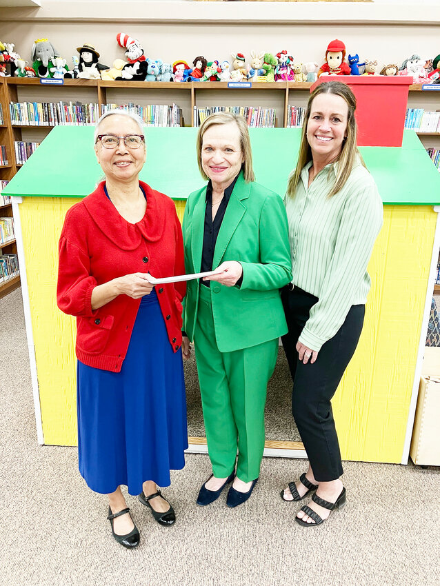 Presenting the donation to Library Director Elizabeth Huff, left, are Citizens First National Bank employees Julie Mooney and Pam Wilken.