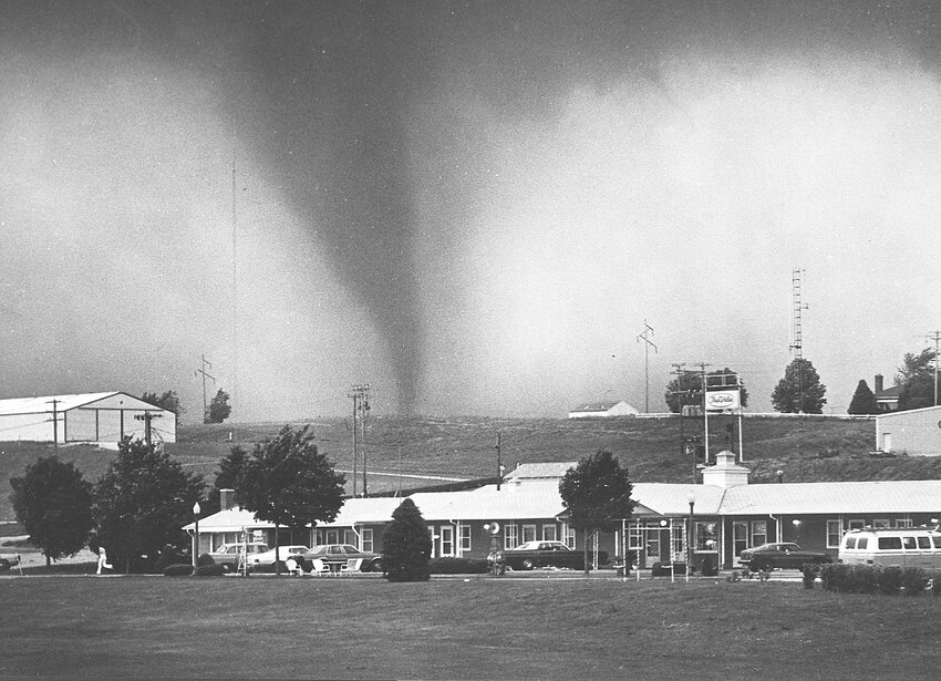Everything in this photo was destroyed by a tornado five minutes after this photo was taken in Algona on June 28, 1979. Note the person running for safety in the lower left. The person survived, but two people died and 34 were injured along with extensive property damage.