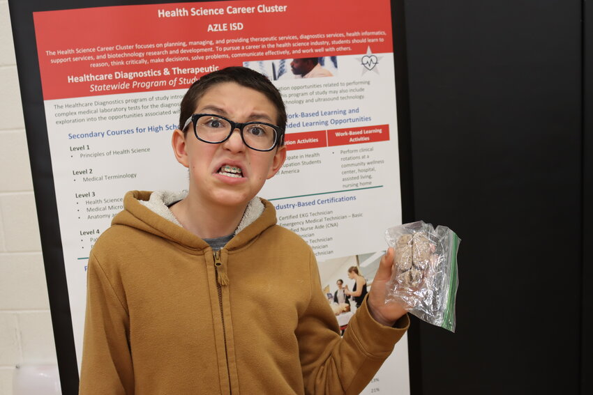 Fifth grader Kayden O’Donald poses with a model brain used by representatives from Azle ISD’s health science career cluster.