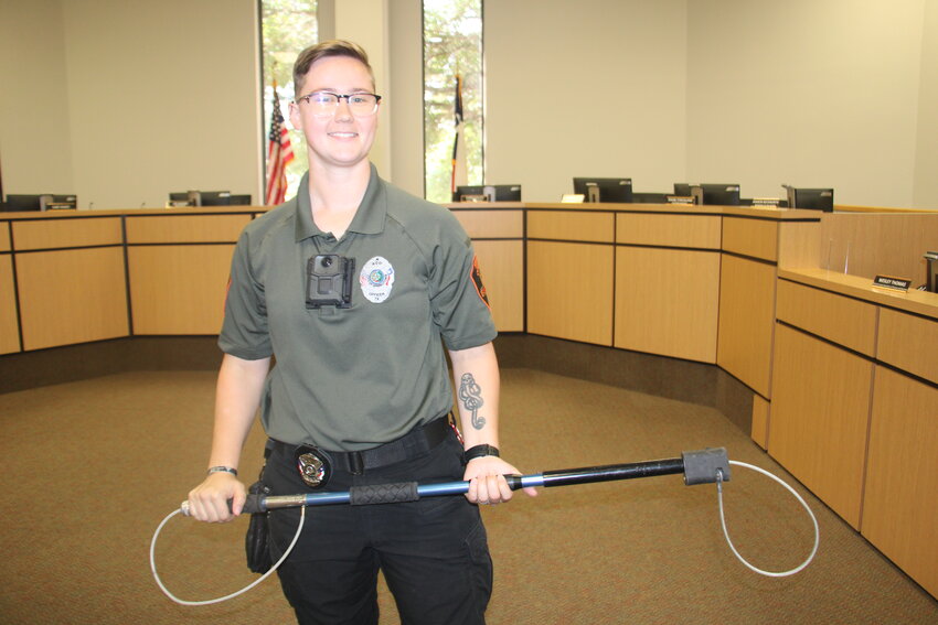 Springtown Animal Control Officer Maddy Gould holds a catcher pole that is used to rein in loose dogs at the citywide job fair June 13. Springtown's animal control department was one of the employers included in the fair.