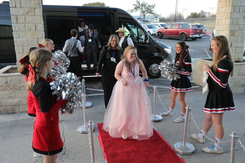 Night to Shine attendee, Greenlee, walks the red carpet leading into the Church At Azle for a special Tim Tebow sponsored prom event, Feb. 7.