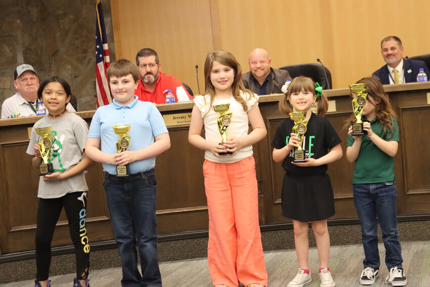 In this photo, (front row, l-r): Fourth grade student Emma Maqueda, third grade student Aiden Spinks, second grade student Bowyn Bradley, first grade student Jane Peinado and kindergartener Olin Holmes. This group of students was recognized Feb. 24 by the Azle ISD board of trustees for placing first in each of their respective grade levels; (back, l-r): Azle ISD trustees Jeff Edwards, Jeremy May and Brandon Geary and Superintendent Todd Smith.