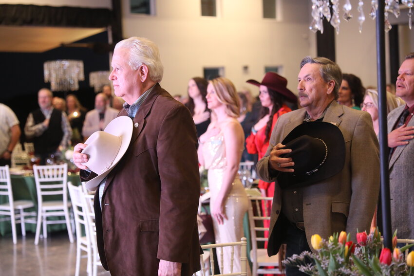 Parker County Sheriff Russ Authier and Precinct 1 Commissioner George Conley place their hats over their hearts for the Pledge of Allegiance at the Springtown Area Chamber of Commerce awards gala last year. This year’s gala takes place on March 1 and is Kentucky Derby-themed.