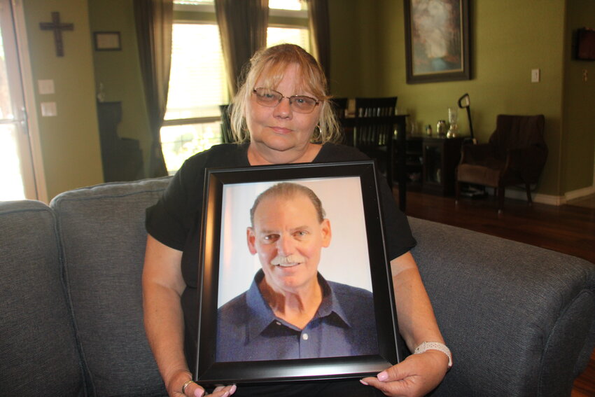 Dranda Hopps holds up a picture of her late husband, who recently died after testing positive for West Nile Virus. Dranda and Gary Hopps were married for about 30 years.