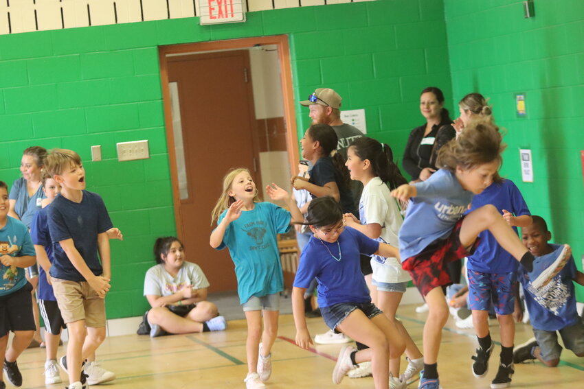 Eagle Heights third graders celebrate after winning in tug-of-war.