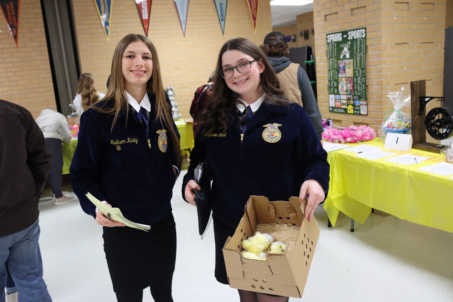 Cheyanne Redd, junior, and Madison Kirby, sophomore, sell plastic eggs containing numbers that gave buyers the chance to win gift cards.