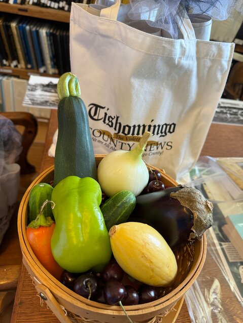 A basket full of locally grown, fresh vegetables, including cherries, Mrs. Gaither's favorite, along with a gift bag from the Tishomingo County News, and a generous gift of Iuka History along with notecards and other memorabilia.