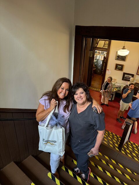 Ladye and her lifelong best friend, Gail Cutshall, take a moment in their visit for a picture while heading to the upstairs courtroom. Ladye is holding a gift bag from the Tishomingo County News.
