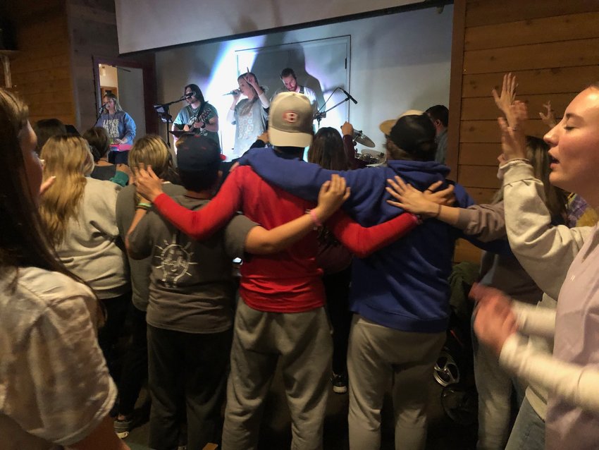 Young people worship during the Saturday night session of D-Now, a county-wide event attended by youth from more than 15 local churches.