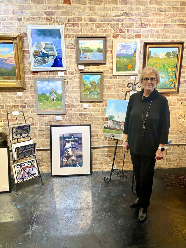 Terrie Whitehurst proudly displays art in her new gallery on Front Street.