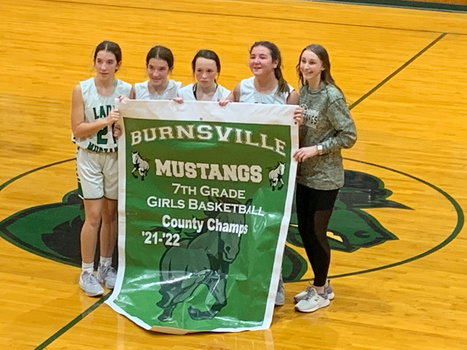 Burnsville's 8th grade girls with their 7th grade county champs banner from last year.