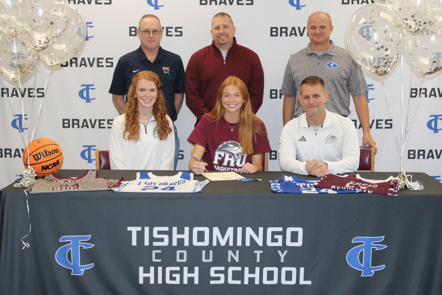 Signing with Freed-Hardeman - Reese Moore, center with Coaches Abby Stutts and Josh Epperson of Freed-Hardeman and standing is Bryon Veal, AAU Coach, and TCHS Coaches Cory Glidewell, and Brian Middleton.