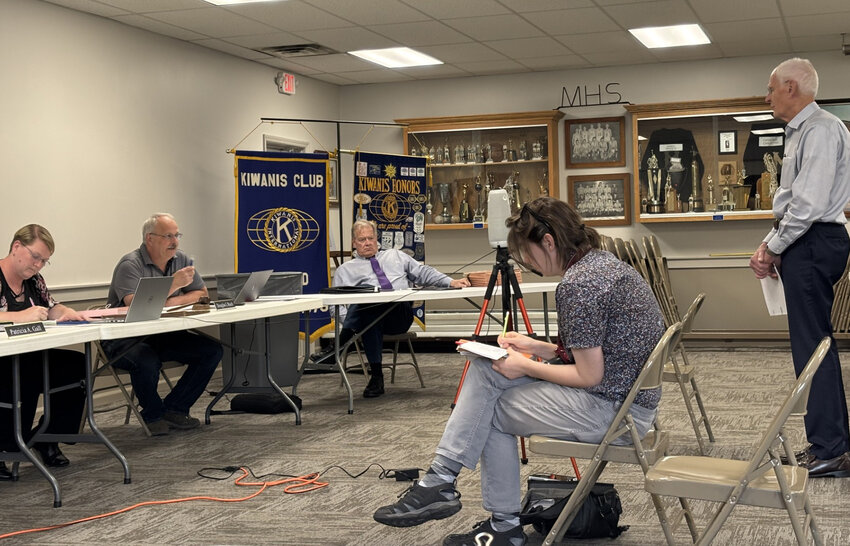Ron Baumgartner (standing) receives the go-ahead from the Milford Town Council to beautify the Fourth Street railroad crossing. Seated (L to R) are Clerk-Treasurer Tricia Gall, Council President Doug Ruch and town attorney Jay Rigdon.