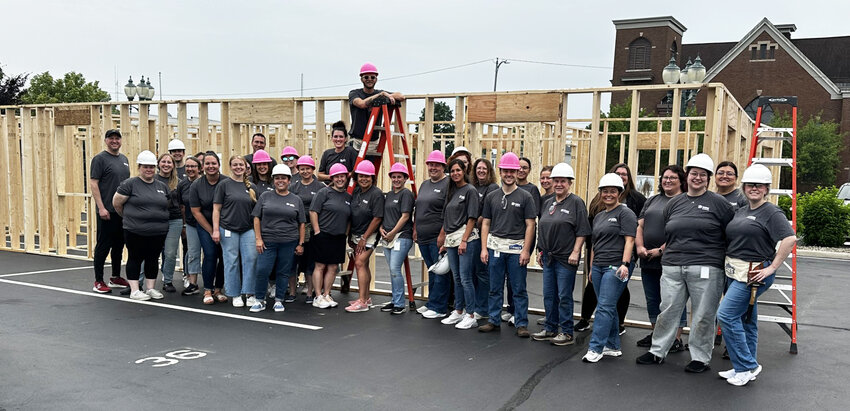After finishing putting the frame together for the Habitat for Humanity of Kosciusko County home Friday, Lake City Bank employees who volunteered for the Panel Build pose for a group picture.