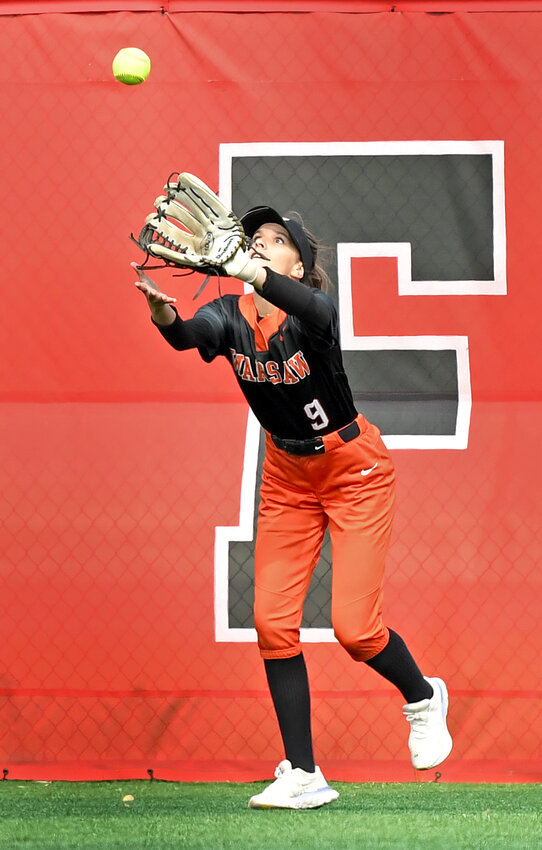 Senior Brooklyn Nibert retreats to the outfield fence to catch a ball during Saturday morning's sectional championship game against Elkhart...Nieter