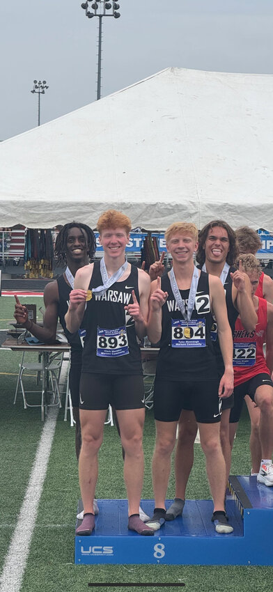 The 4x800M team of (L-R) Noah McPhail, Clark Meridew, Tyler Mimnaugh and Rick Orr stand on the podium after setting a school record in the final race of their high-school careers.
