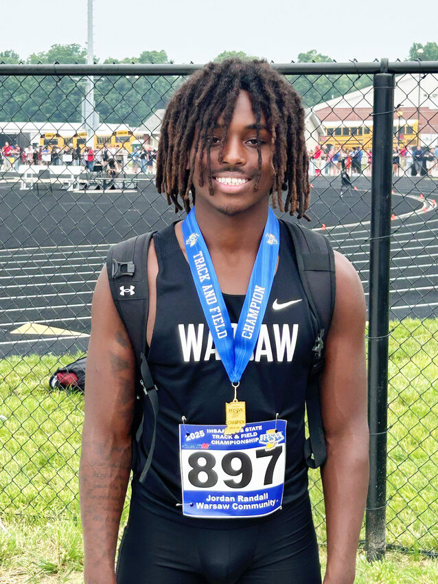 Warsaw junior Jordan Randall takes a picture with his medal after winning the state championship in high jump on Friday.