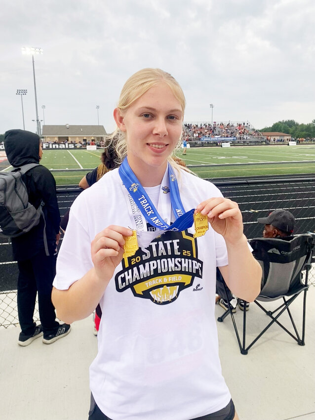 Whitko's Gwen Howard poses with her two medals after winning a state title in shot put and finishing third in discus at the IHSAA Girls Track and Field State Finals Saturday.