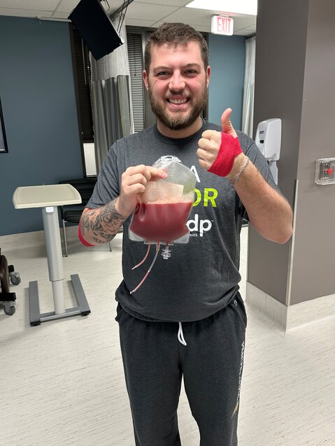 Terran Sievers holds his donation after spending hours in a donor clinic in Houston, Texas on March 21.