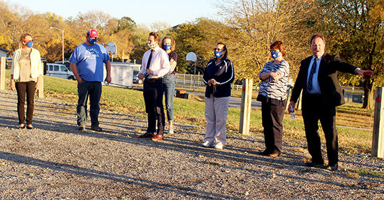 Wayne Community Schools' Superintendent Dr. Mark Lenihan (right) explains to board members to the work to be done on the parking lot south of the Junior-Senior High School during Monday's board meeting.