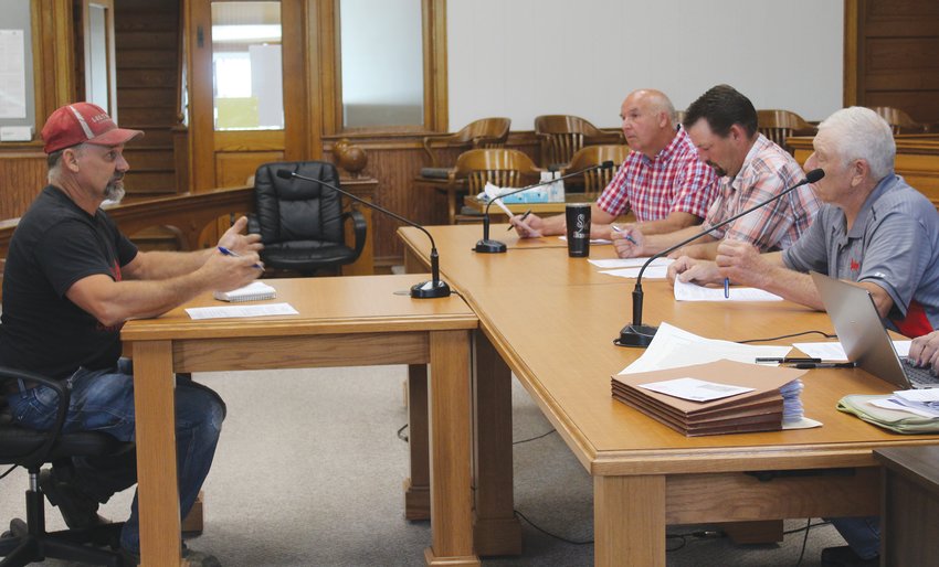 Lucas Thompson (left) spoke to the Wayne County Commissioners on his request to vacate a 12 foot utility easement in the Tuffern Blue Estates subdivision north of Wayne.