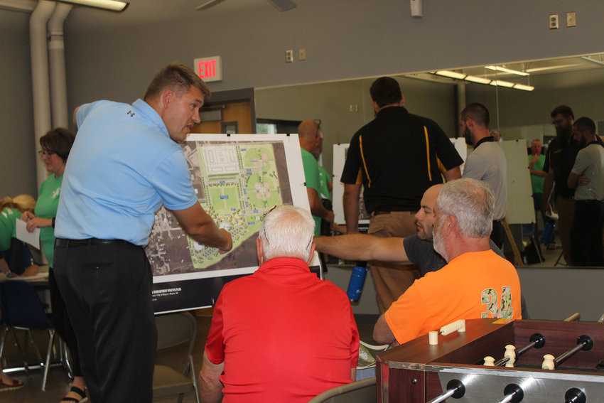 (Photo by Clara Osten)  City Administrator Wes Blecke (left) explains some of the features proposed for the area that once was the city's lagoon.