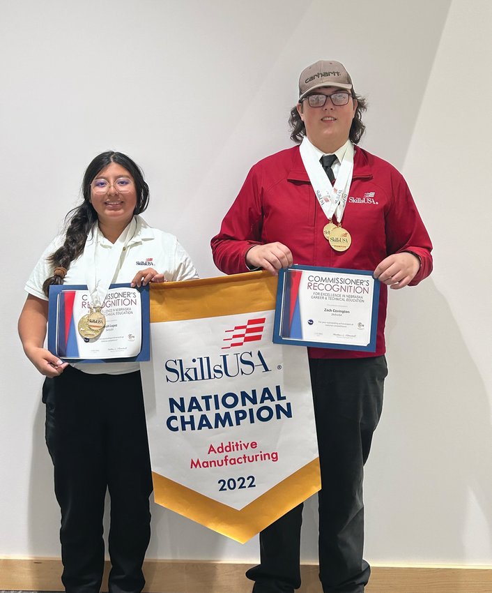 Sarahi Lopez (left) and Zach Covington display the banner they received for earning a SkillsUSA National Championship in Atlanta, Georgia earlier this year.
