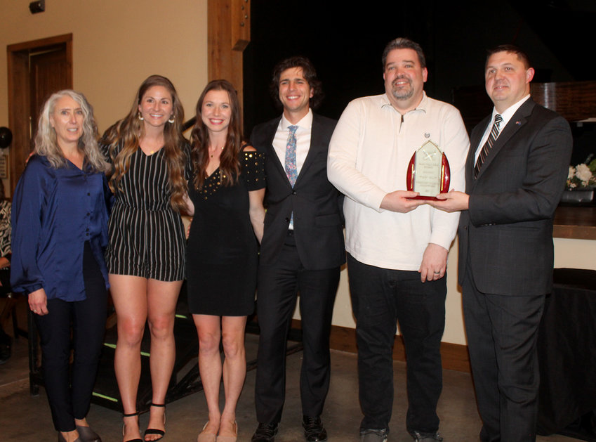 Justin Raulston (second of the right) accepts the Patron of the Year from WAED Director Luke Virgil. With him are members of the staff of CSF and The Table.
