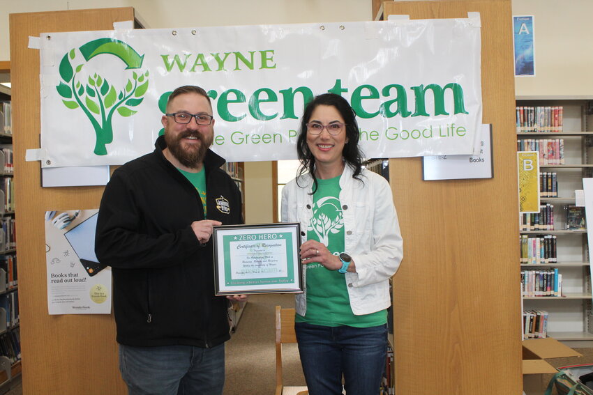 Sandy Brown presents Greg Ptacek, owner of Johnnie Byrd Brewing Company, with the Wayne Green Team&rsquo;s Zero Hero Award.