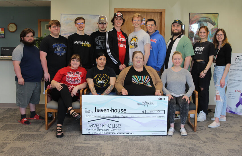 Students from Wayne State College&rsquo;s KWSC-FM radio station present a check for $1,250 to Haven House in Wayne. The funds were raised during a 24-hour live stream broadcast that raised awareness for domestic violence survivors. Pictured are Haven House staff members (front row, left to right) Katie Gannon, outreach coordinator; Tamara Torres, bilingual advocate; Connie Reyes, domestic violence and sexual assault supervisor and Amber Bruegman, shelter advocate. Students in the back row (left to right): Quin Otto, Genoa; Joe Merkel, Wynot; Grant Ferrell, Lincoln, Tucker Ashburn, Riley, Kansas; Nate Bope, Omaha; Nathan Reiland-Smith, Sioux Falls, South Dakota; Blake Hilkemeier, Atkinson; Griffin Presnell, Lincoln; Hailey Walsh, Wakefield and Jasmine Snyder, Fairbury.