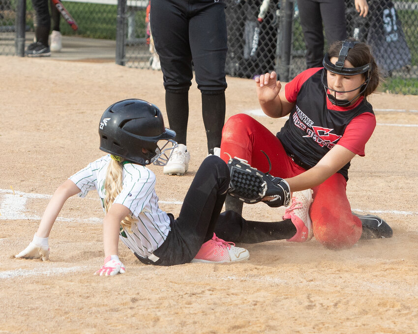 Dirt Devils 10-under black pitcher Harper Hanson tries to make a tag on a Kelly&rsquo;s runner during tournament action at the Wayne Summer Sports Complex over the weekend.