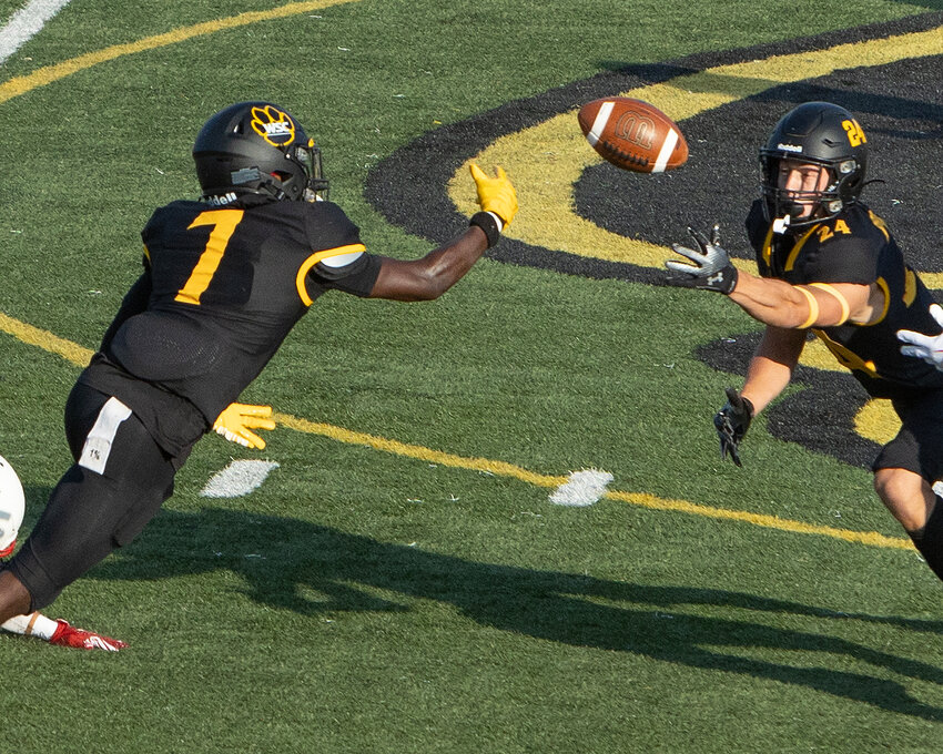 Marzion Cosby (7) and Jacob Byrd both reach for a tipped pass during Wayne State&rsquo;s 31-23 win over MSU Morehead in the season opener for both teams Friday at Cunningham Field.