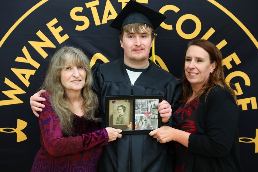 Evan Brasch (center) became the fourth generation in his family to graduate from Wayne State College. Other family graduates are his grandmother Joyce Schmitz Buskohl (left) in 1977, his mother Stacy (Bartak) Brasch (right) in 1994, and his great grandmother Viola Homan Schmitz (in the photo they are holding), in the 1930s.