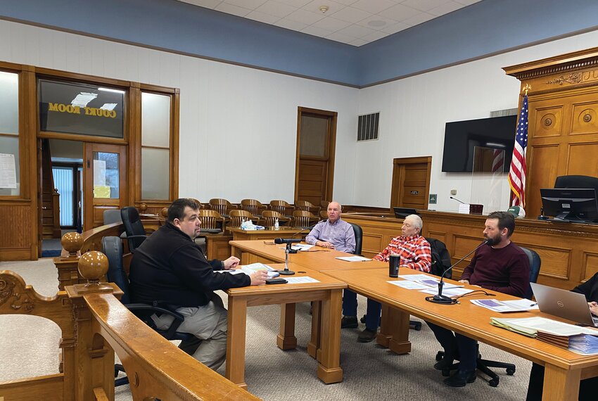 Wayne County Emergency Manager Nic Kemnitz (left) updated the Commissioners on the recent storm. Kemnitz and others worked with various organizations to keep the public informed, ensure safety and get life in the area back to normal as quickly as possible.