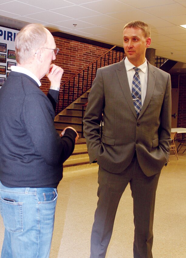 Russ Plager (right) visits with Rusty Parker following last week's Meet & Greet. Plager was chosen as the new high school principal for Wayne Community Schools.