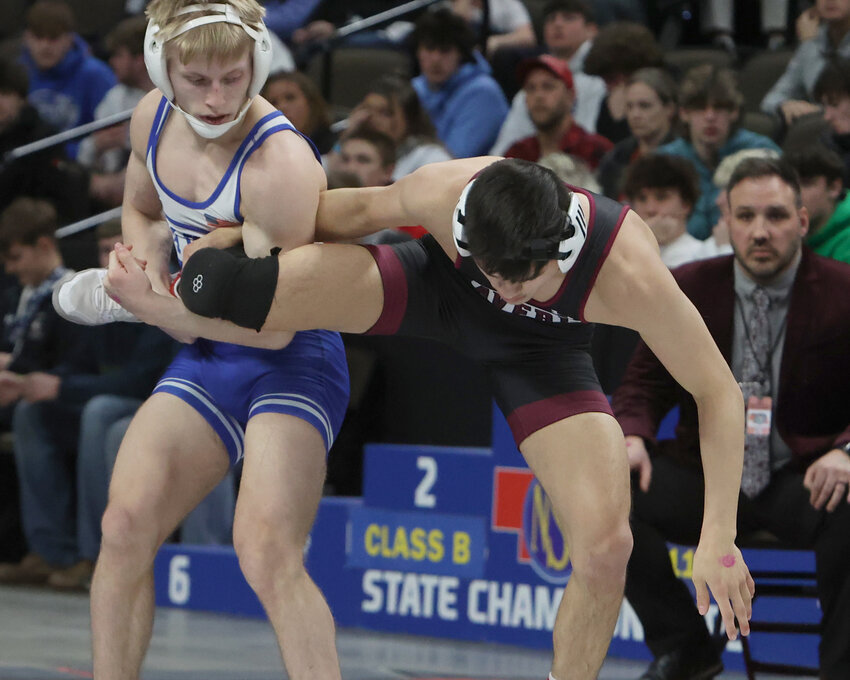 Wayne High senior Garret Schultz tries to control Hunter Jacobsen of Waverly in their Class B 120-pound finals match at the State Wrestling Championships in Omaha. Jacobsen won on a 9-1 major decision to leave Schultz with the runner-up medal. (Photo by Michael Carnes)