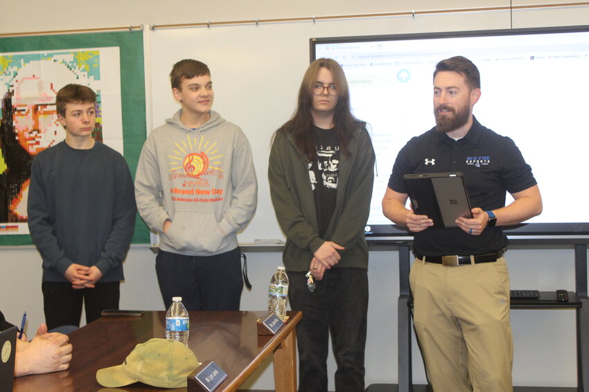 Aidan Bohnert (left), Colby Raulston, Harrison Collier and Coach Alex Wieland spoke to the board on the e-sports program currently in place at Wayne Community Schools.